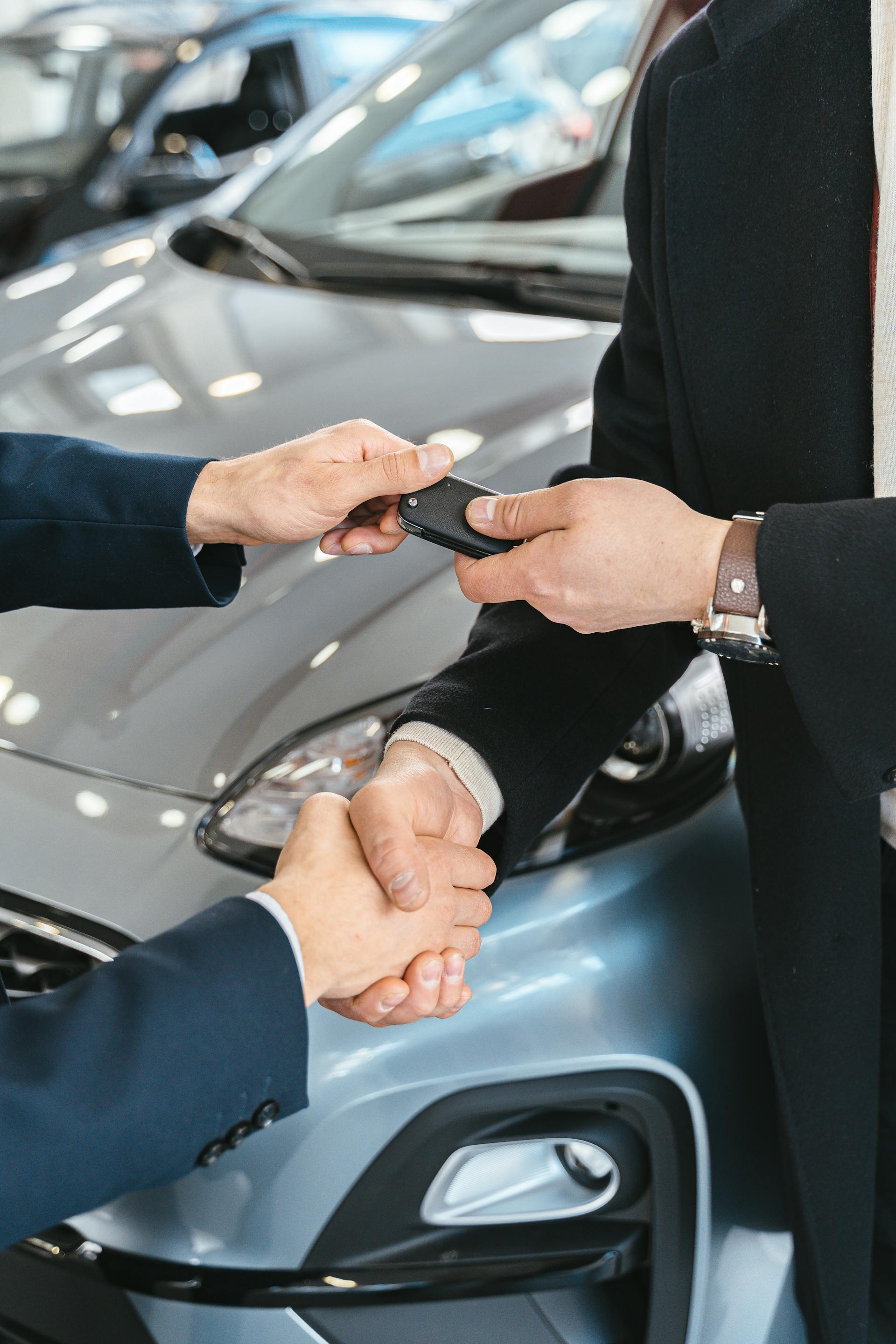 Handshake at a dealership as keys to a new vehicle are exchanged
