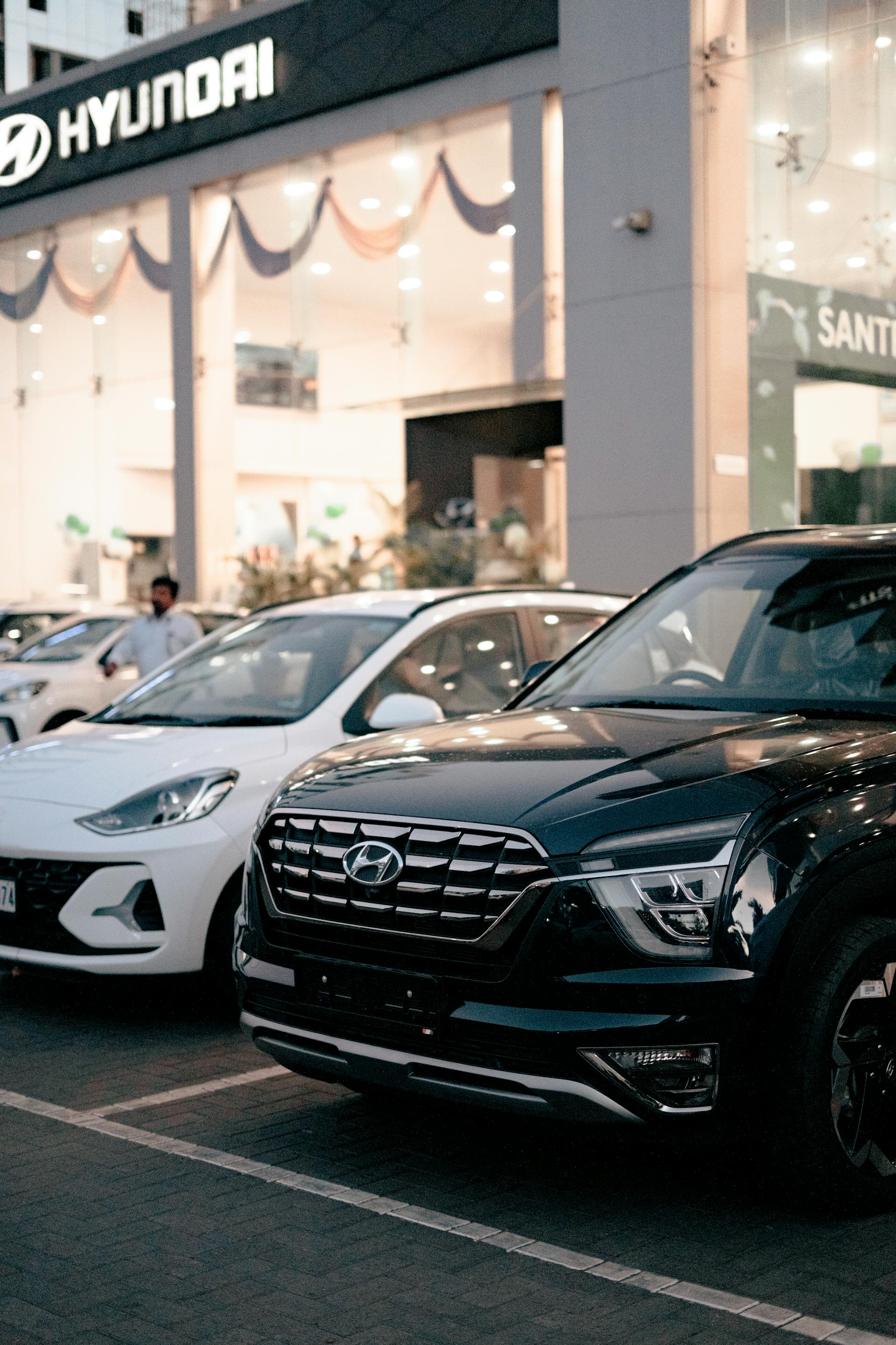 Lineup of new SUVs parked side by side at a modern dealership